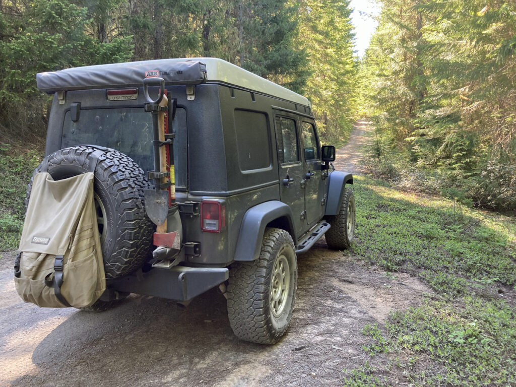 The Trasharoo bag on the back of my Jeep, on a forest road